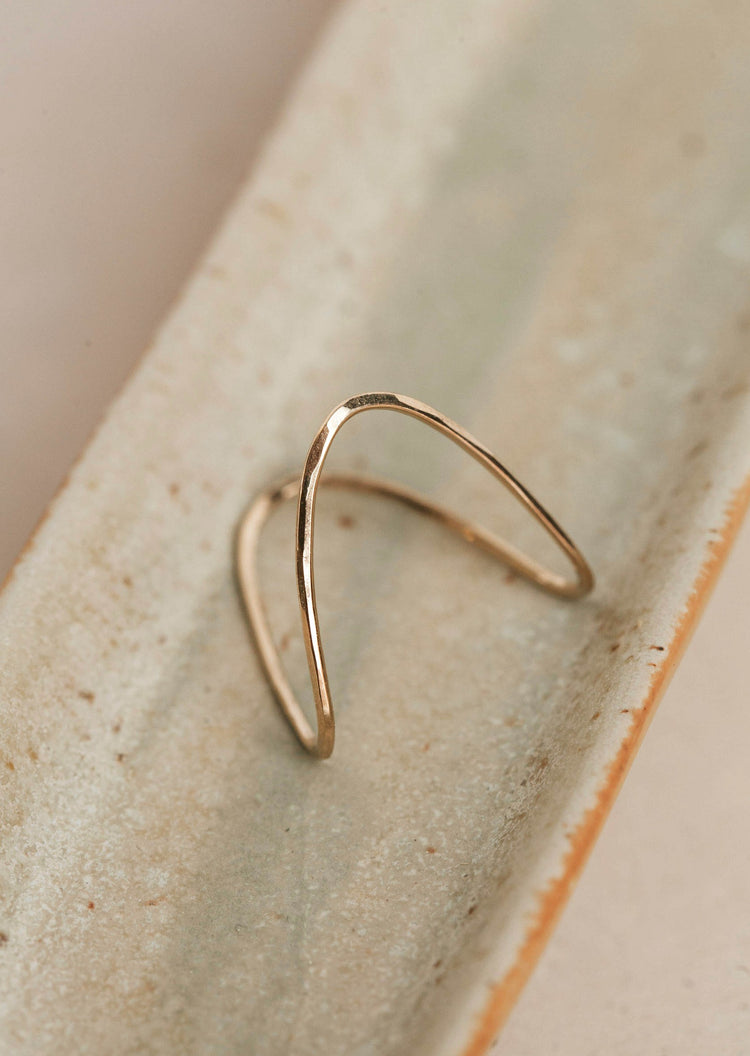 A close up look of the Swell Ring created by Hello Adorn, this ring started as a gold wire ring and was handmade into a wave ring.