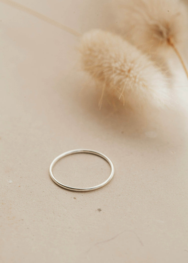 Teeny-Tiny Band by Hello Adorn as a silver stacking ring. 