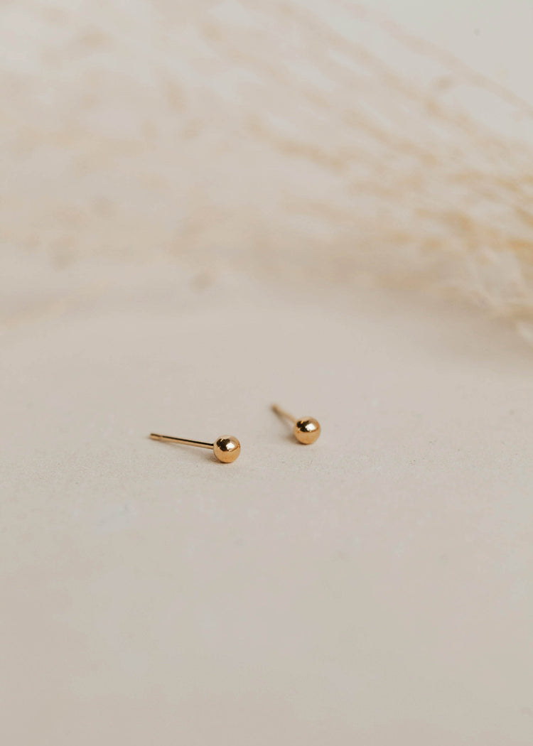 Gold ball earrings in a stud earring style created for everyday earrings or complete your earring stack with these gold small stud earrings by Hello Adorn.