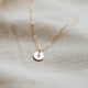 Tiny initial necklace that is hand stamped jewelry by Hello Adorn.