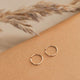 Gold Hoop Earring laying flat by Hello Adorn great for minimalist jewelry.