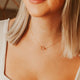 Model wearing a gold double circle necklace by Hello Adorn.